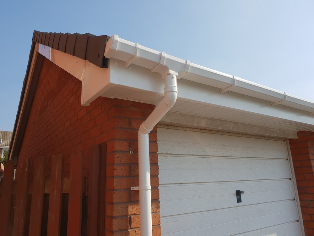 White guttering and fascia along a residential roofline
